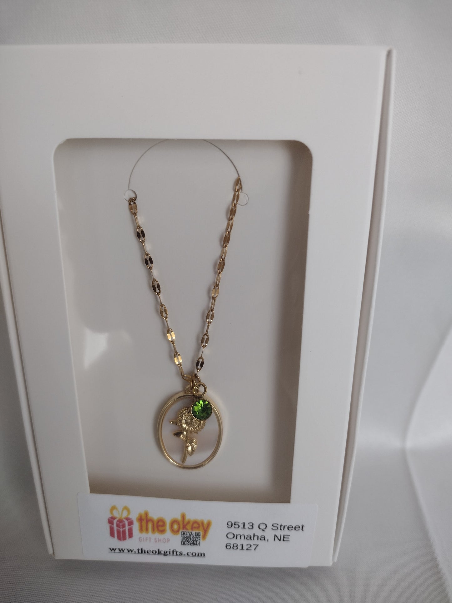 Golden sunflower & peridot charm