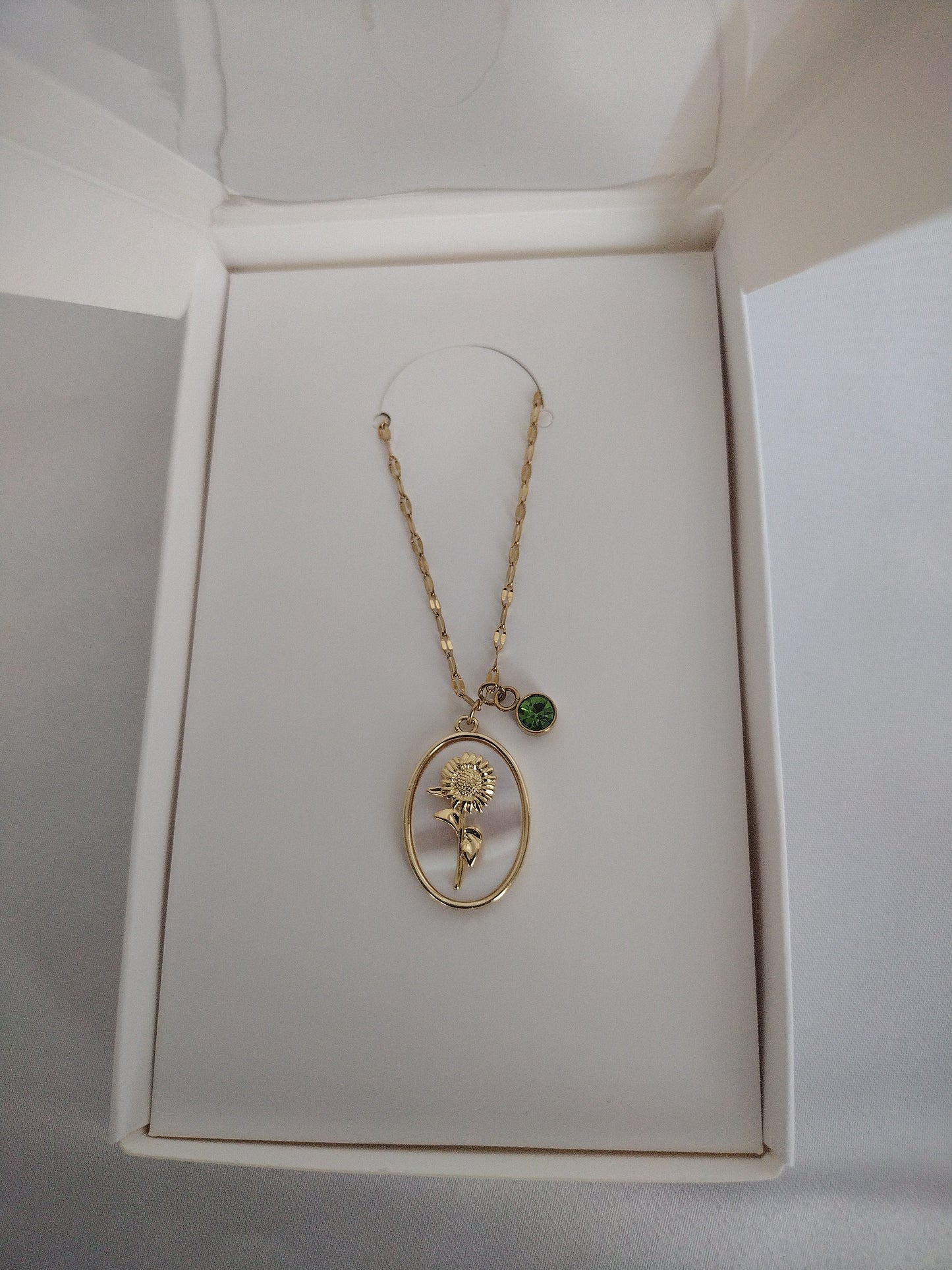 Golden sunflower & peridot charm