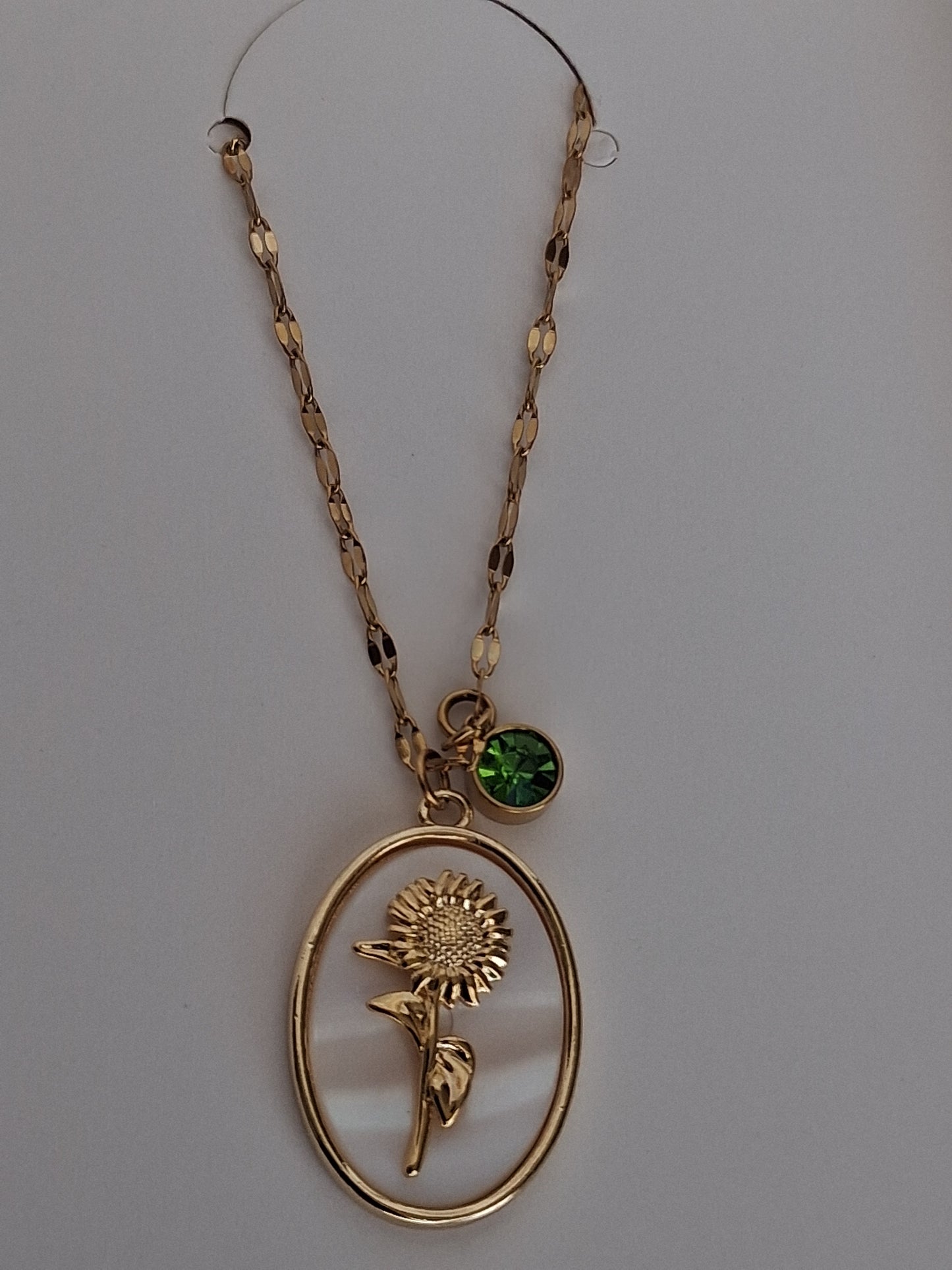 Golden sunflower & peridot charm