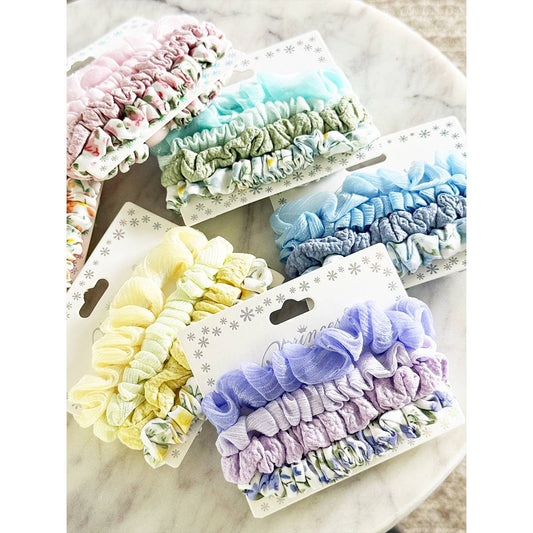 Set of colorful scrunchies on a marble surface
